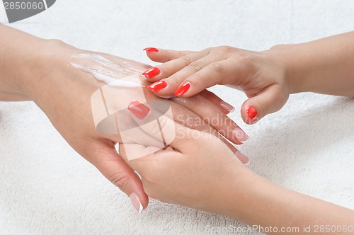 Image of beauty salon, hands massage with moisturizing cream