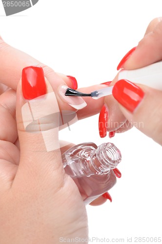 Image of manicure, applying clear enamel