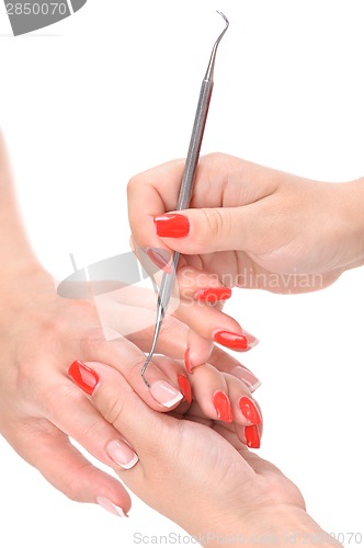 Image of manicure applying - cleaning the cuticles 