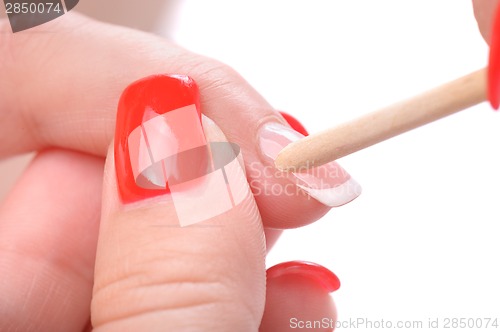 Image of manicure applying - cleaning the cuticles 