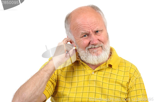 Image of bald senior man picking his ear