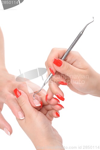 Image of manicure applying - cleaning the cuticles 