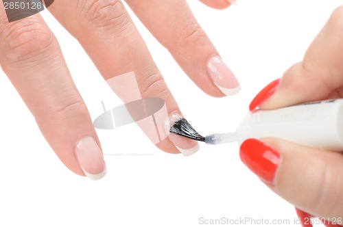 Image of manicure, applying clear enamel