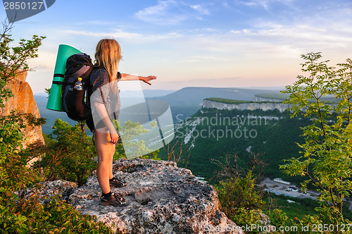 Image of Hiking woman in rays of sunset