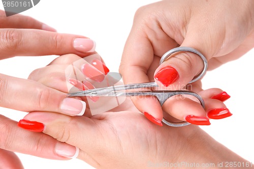 Image of manicure applying - cutting the cuticle 