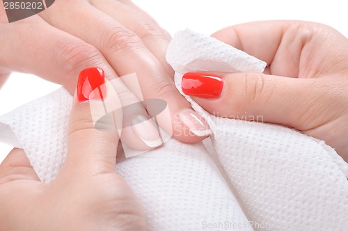 Image of manicure applying - wiping and cleaning