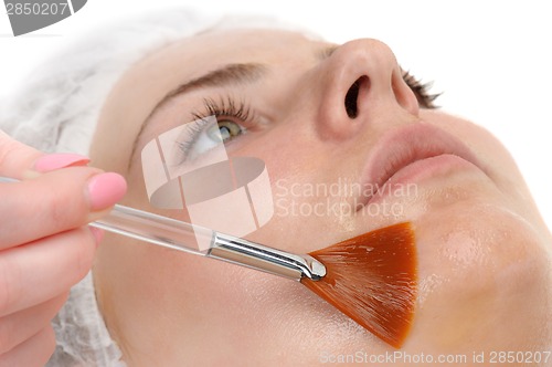 Image of facial peeling mask applying