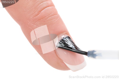 Image of manicure, applying clear enamel