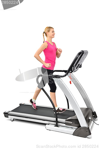 Image of young woman doing exercises on treadmill