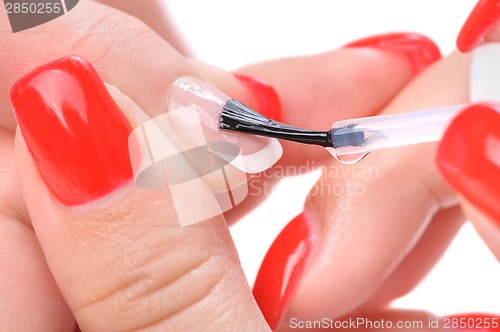 Image of manicure, applying clear enamel