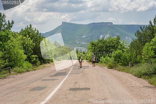Image of Two hiking people on the road