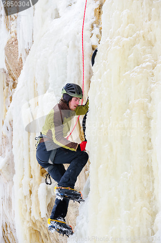 Image of Young man climbing the ice