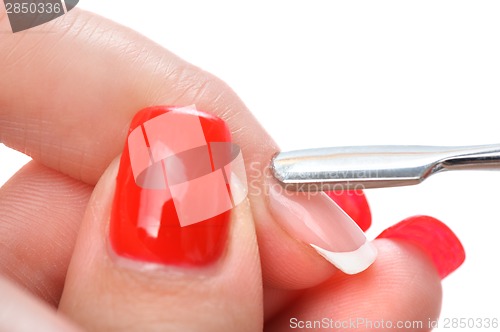 Image of manicure applying - cleaning the cuticles 