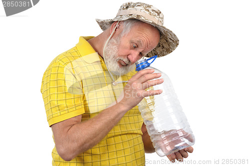 Image of senior man looking into empty bottle