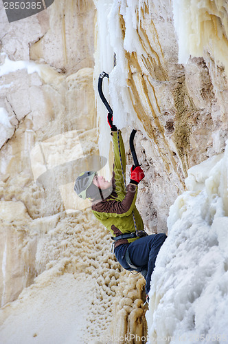 Image of Young man climbing the ice