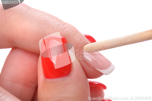 Image of manicure applying - cleaning the cuticles 