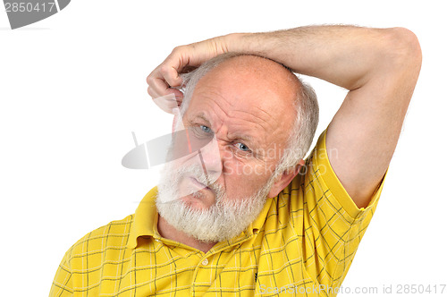 Image of balding senior man skratching his other ear