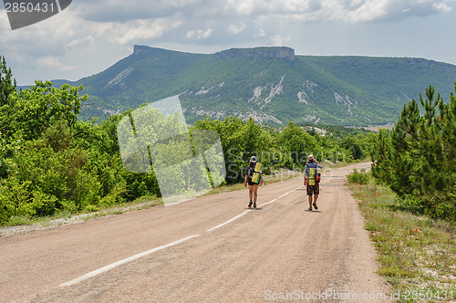 Image of Two hiking people on the road