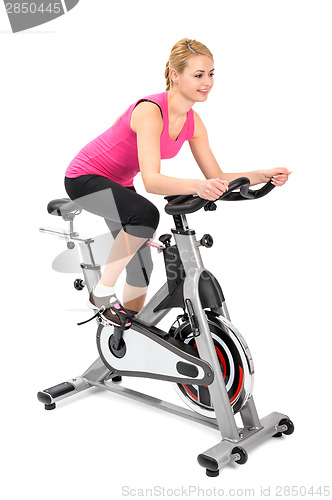 Image of young woman doing indoor biking exercise