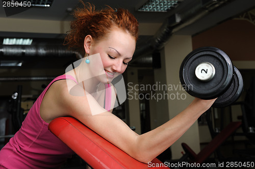 Image of Slim girl doing biceps traning