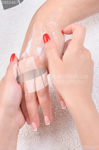 Image of hands skin care - cream applying