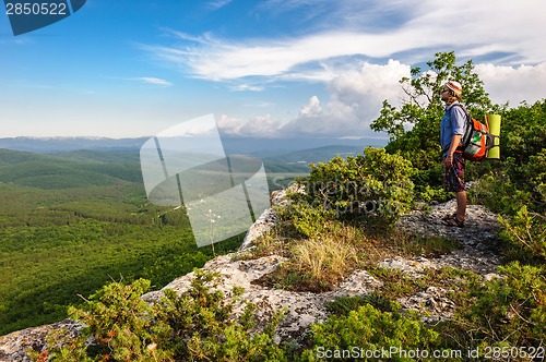 Image of Hiking man in rays of sunset