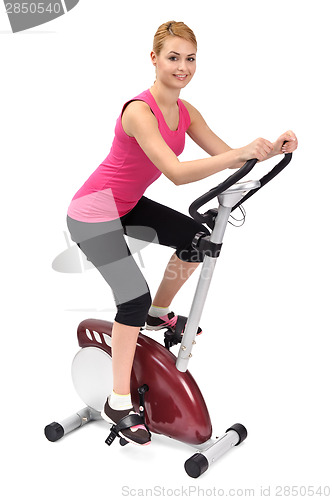 Image of young woman doing indoor biking exercise