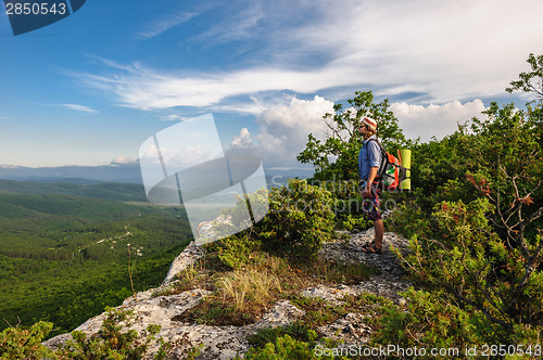 Image of Hiking man in rays of sunset