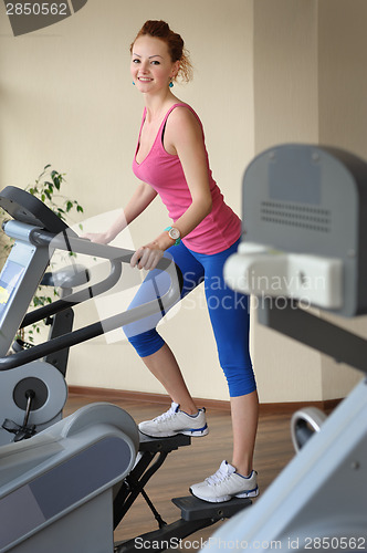 Image of young girl doing step machine workout
