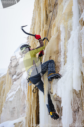 Image of Young man climbing the ice