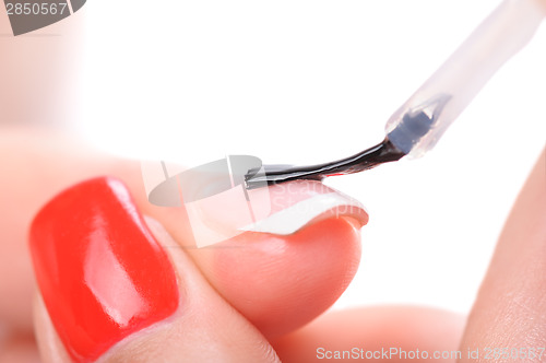 Image of manicure, applying clear enamel