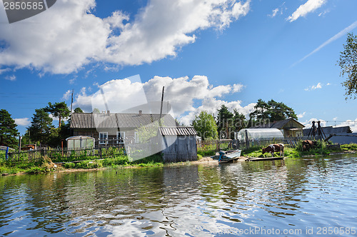 Image of Russian wooden houses at river bank