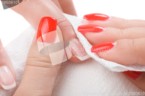 Image of manicure applying - wiping and cleaning