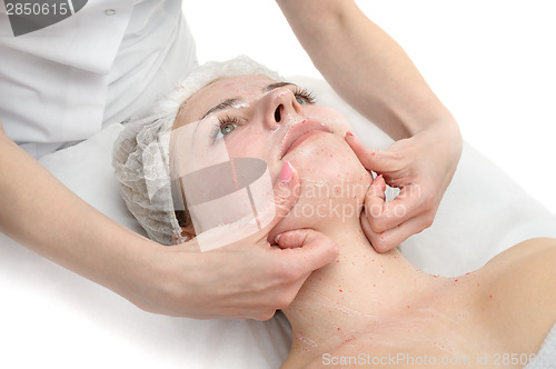 Image of facial massage with scrub mask 