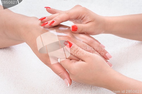 Image of beauty salon, hands massage with moisturizing cream