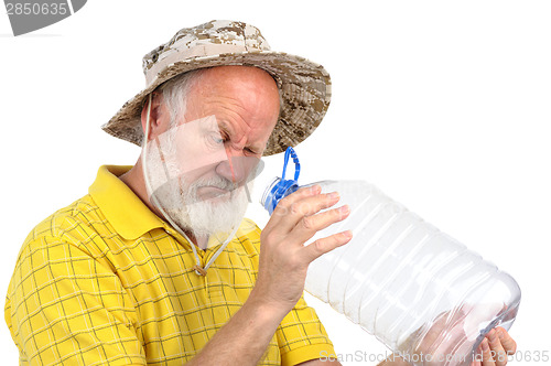 Image of senior man looking into empty bottle