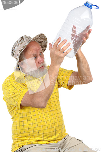 Image of senior man looking into empty bottle
