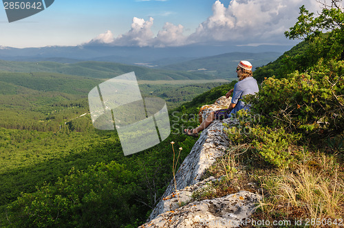 Image of Hiking man in rays of sunset