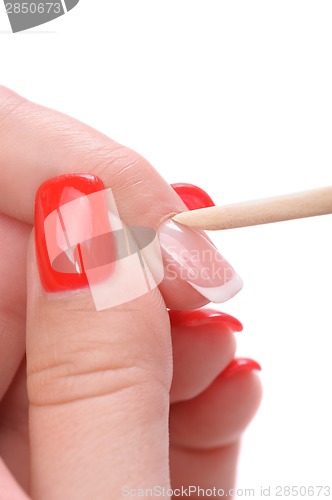 Image of manicure applying - cleaning the cuticles 