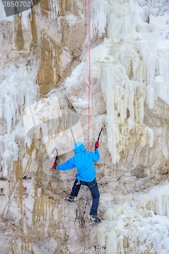 Image of Young man climbing the ice