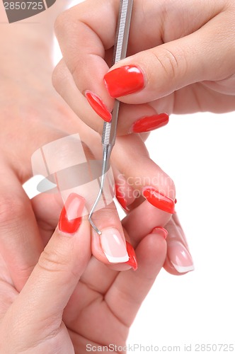 Image of manicure applying - cleaning the cuticles 