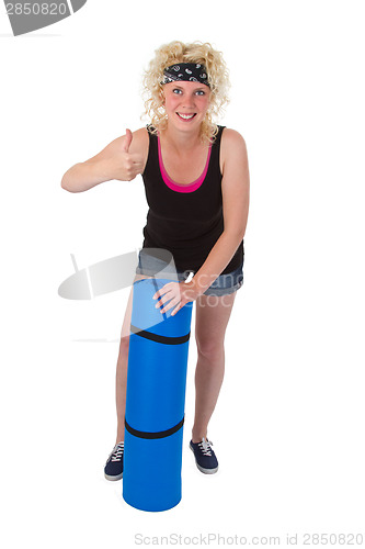Image of Young woman with gym  mat