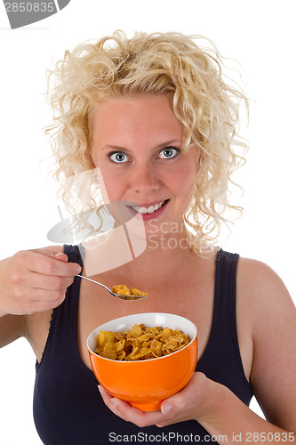 Image of Young woman eating cornflakes