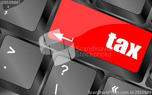 Image of tax word on laptop keyboard key, business concept,