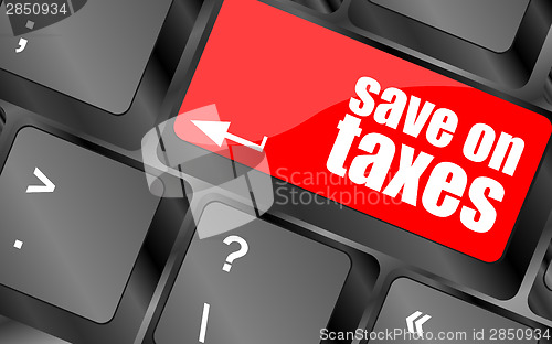 Image of save on taxes word on laptop keyboard key, business concept