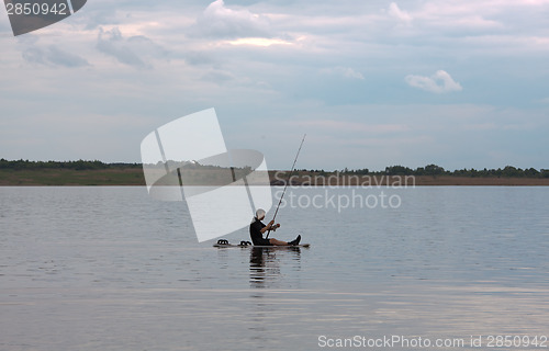 Image of Surfer and fisherman simultaneously