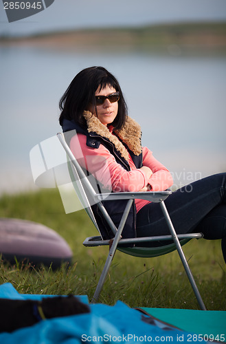 Image of Woman sitting in chair at campsite