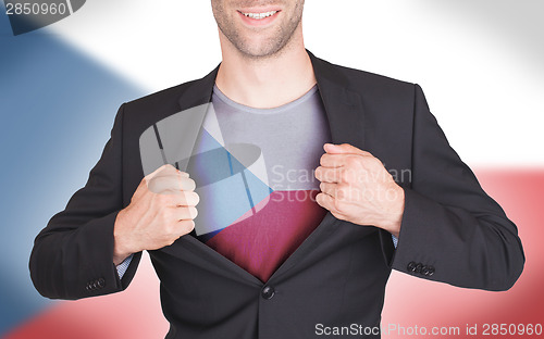 Image of Businessman opening suit to reveal shirt with flag