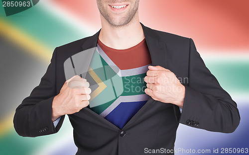 Image of Businessman opening suit to reveal shirt with flag