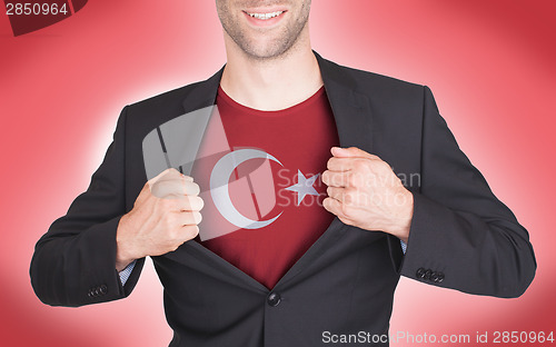 Image of Businessman opening suit to reveal shirt with flag